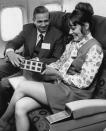 <p>J. Willard Marriott, president of the eponymous hotel chain, smiles with the flight attendant on a flight in 1973.</p>