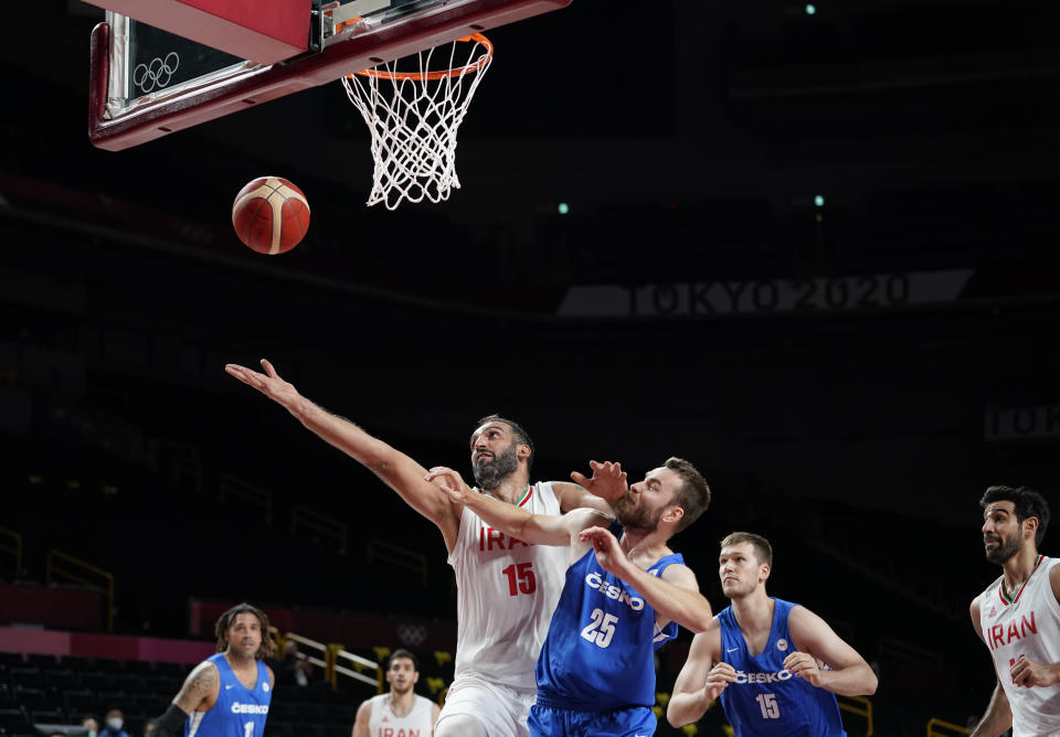 Iran's Hamed Haddadi (15) and Czech Republic's David Jelinek (25) fight for a rebound during men's basketball game at the 2020 Summer Olympics, Sunday, July 25, 2021, in Saitama, Japan. (AP Photo/Charlie Neibergall)