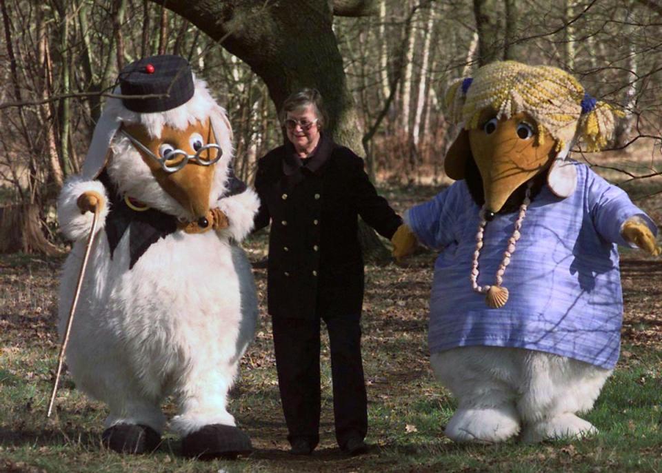 Elisabeth Beresford walks with Wombles Uncle Bulgaria and Alderney in the woods of Wimbledon Common (PA) (PA Archive)