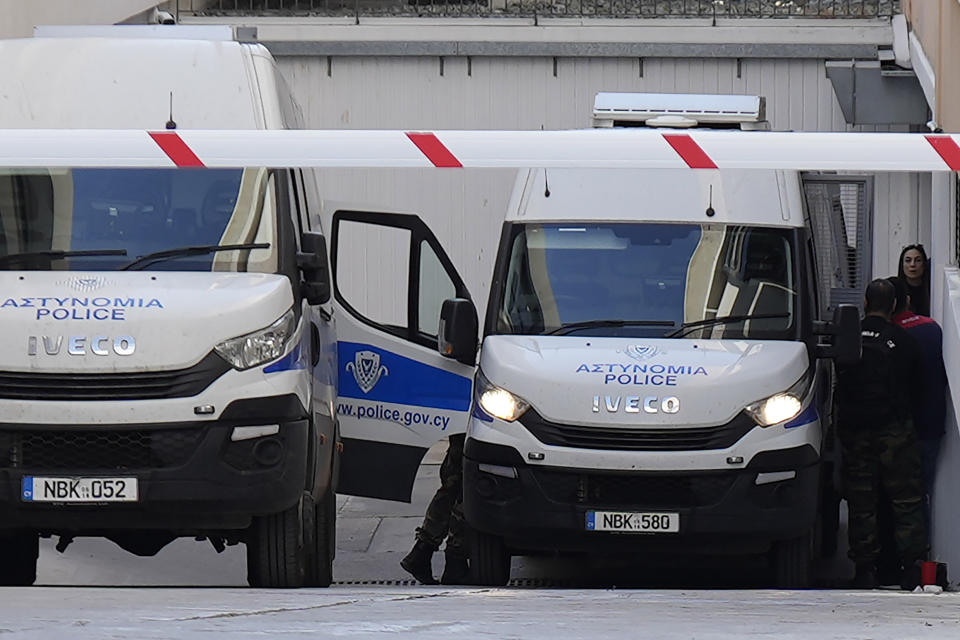 Officers stand by a police van as they leave the grounds of the courthouse complex after the trial of David Hunter in the southwest coastal city of Paphos, Cyprus, Monday, Dec. 5, 2022. A British man facing a premeditated murder charge over the death of his ill wife in Cyprus’ coastal resort town of Paphos is expected to plead guilty to the lesser charge of manslaughter on Dec. 13, with the court to pass sentence at a later date, a state prosecutor said Monday. (AP Photo/Petros Karadjias)