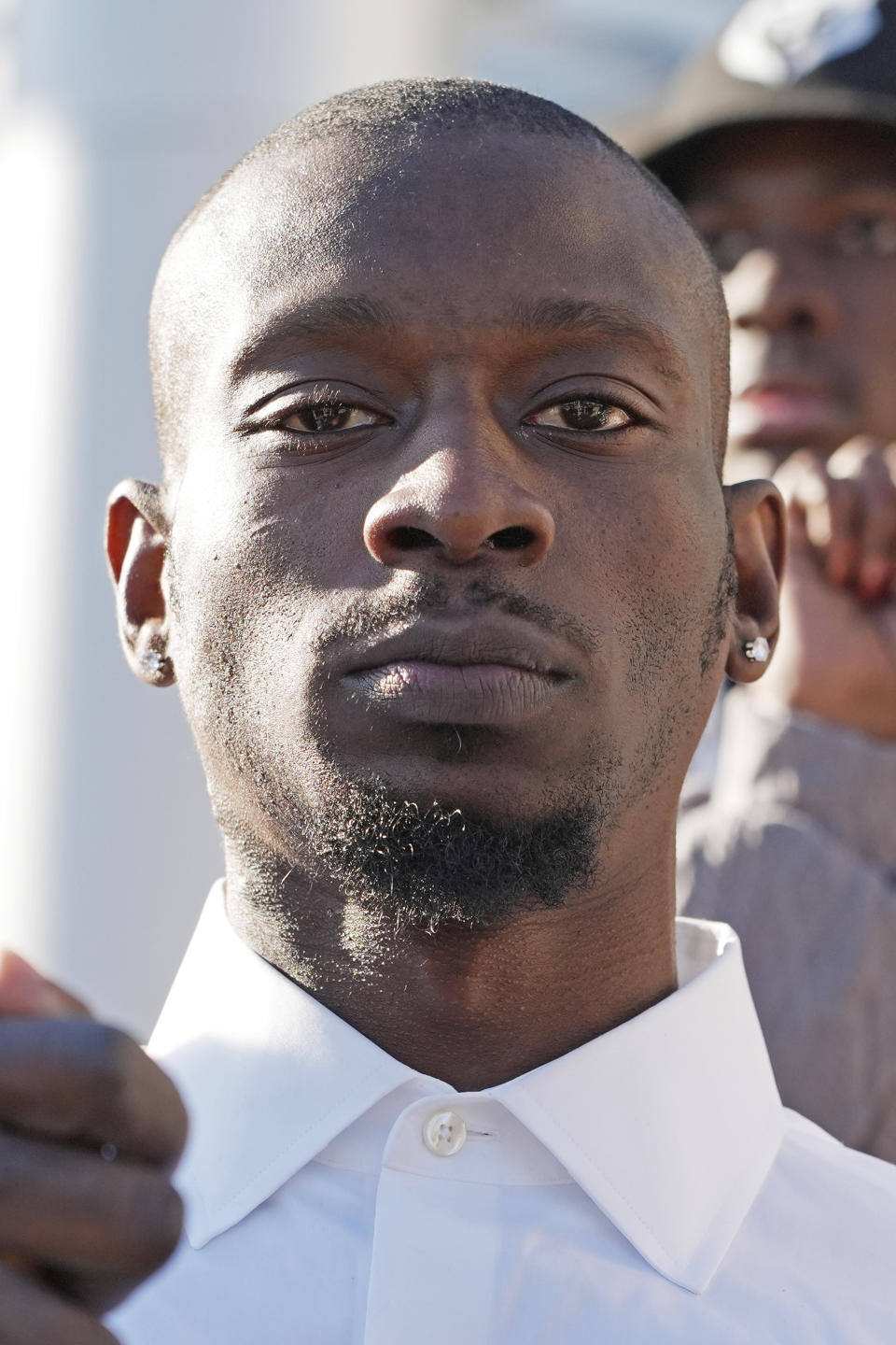 Michael Corey Jenkins stands with supporters outside the courthouse in Jackson, Miss., Tuesday, March 19, 2024, calling for harsh penalties against six former law enforcement officers who committed numerous acts of racially motivated, violent torture on himself and his friend Eddie Terrell Parker in 2023. The six former law officers pleaded guilty to a number of charges for torturing them and sentencing begins Tuesday in federal court. (AP Photo/Rogelio V. Solis)