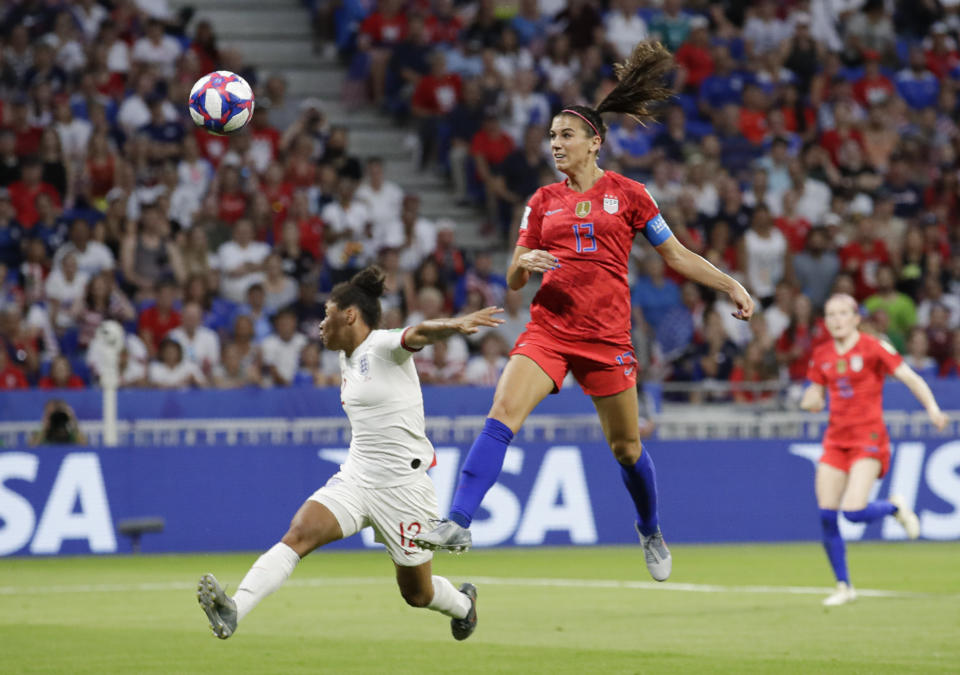 United States' Alex Morgan, right, scores her side's second goal, during the Women's World Cup semifinal soccer match between England and the United States, at the Stade de Lyon, outside Lyon, France, Tuesday, July 2, 2019. (AP Photo/Alessandra Tarantino)