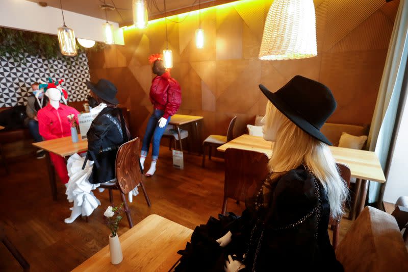 Mannequins dressed in creations of local designer sit at the tables in a restaurant during the coronavirus disease (COVID-19) outbreak in Vilnius