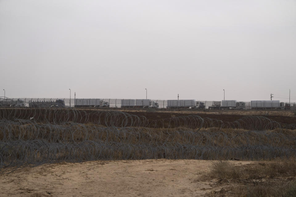 FILE - Trucks, carrying humanitarian supplies for the Gaza Strip, wait in line on the Egyptian side, at the Kerem Shalom Crossing border as seen from southern Israel, Thursday, April 25, 2024. A persistent breakdown in law and order is rendering an aid route in south Gaza unusable, the UN and NGOs say, days after Israel's military said it would pause combat there to help aid reach desperate Palestinians. (AP Photo/Leo Correa, File)