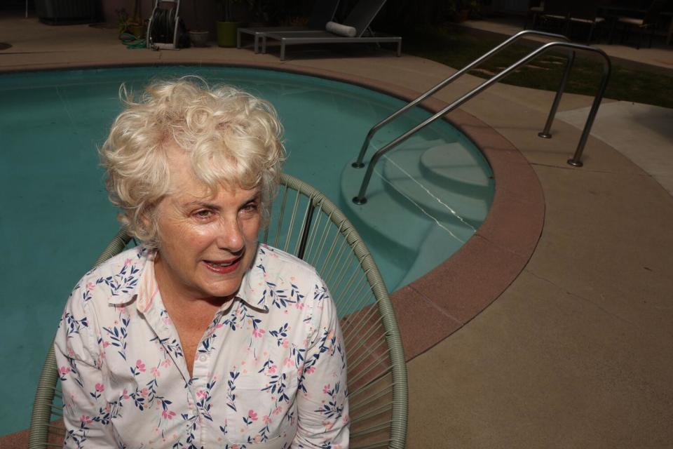 Jean Young poses for a portrait near her pool in her home on Friday in Long Beach. Young has used AirBnB for over ten years.