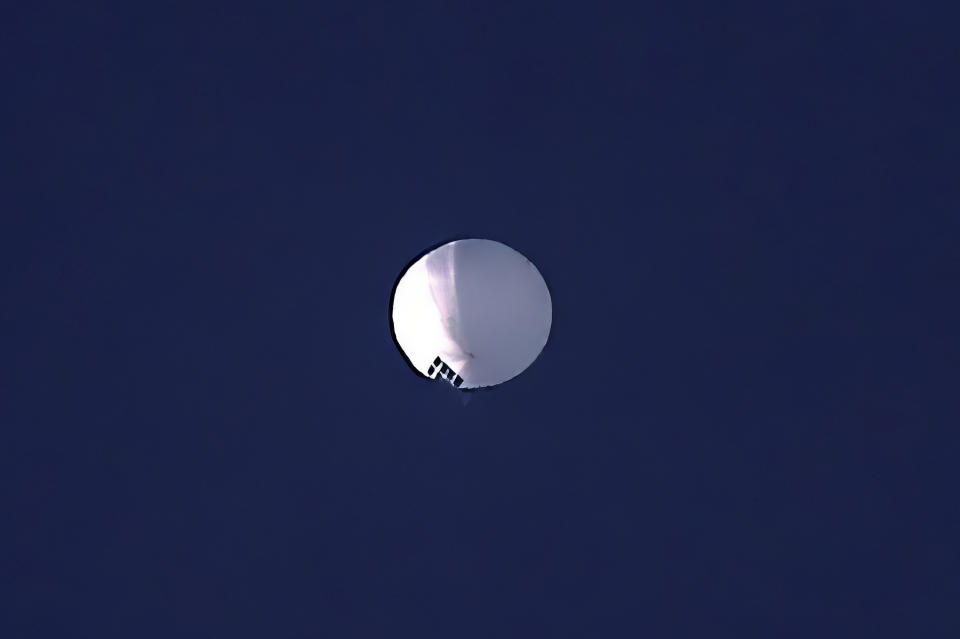 FILE - A high altitude balloon floats over Billings, Mont., on Wednesday, Feb. 1, 2023. Perhaps no other term than spy balloon this year defined the growing wariness between the world's two largest economies. China rejected allegations of surveillance and insisted that balloon and others were purely for civilian purposes. (Larry Mayer/The Billings Gazette via AP, File)