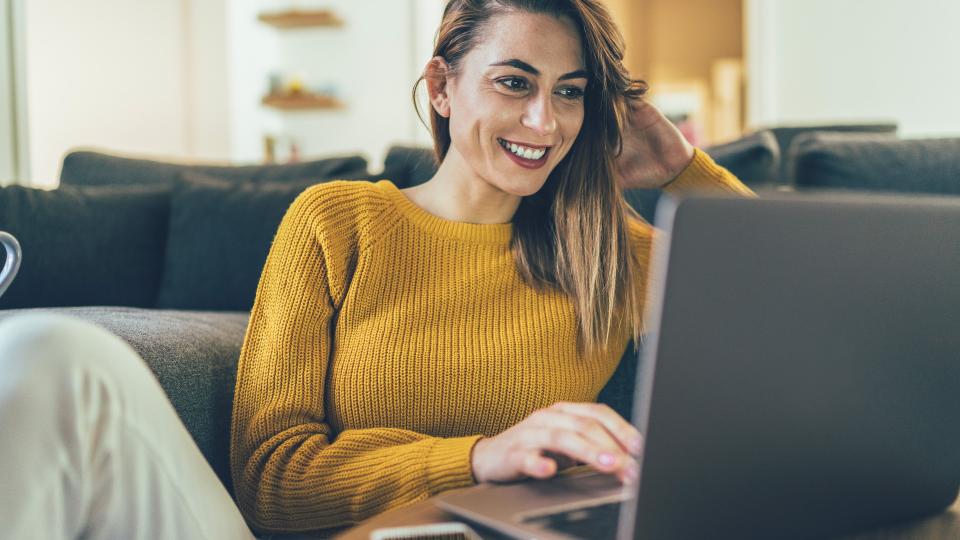 Young beautiful woman using lap top, surfing the net, relax at home.