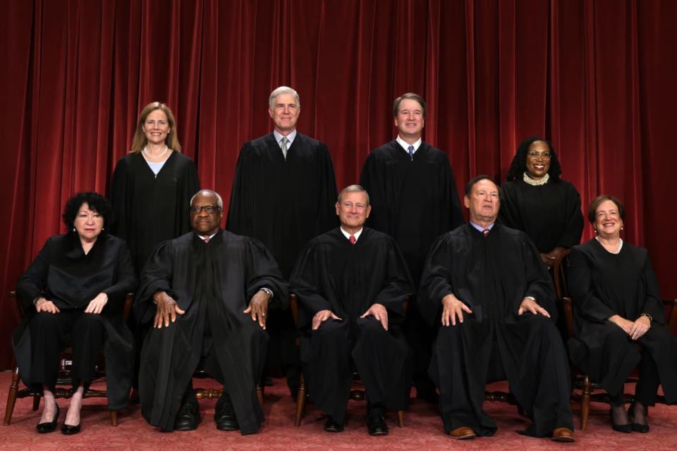 United States Supreme Court (front row L-R) Associate Justice Sonia Sotomayor, Associate Justice Clarence Thomas, Chief Justice of the United States John Roberts, Associate Justice Samuel Alito, and Associate Justice Elena Kagan, (back row L-R) Associate Justice Amy Coney Barrett, Associate Justice Neil Gorsuch, Associate <span class="caas-xray-inline-tooltip"><span class="caas-xray-inline caas-xray-entity caas-xray-pill rapid-nonanchor-lt" data-entity-id="Brett_Kavanaugh" data-ylk="cid:Brett_Kavanaugh;pos:4;elmt:wiki;sec:pill-inline-entity;elm:pill-inline-text;itc:1;cat:Judge;" tabindex="0" aria-haspopup="dialog"><a href="https://search.yahoo.com/search?p=Brett%20Kavanaugh" data-i13n="cid:Brett_Kavanaugh;pos:4;elmt:wiki;sec:pill-inline-entity;elm:pill-inline-text;itc:1;cat:Judge;" tabindex="-1" data-ylk="slk:Justice Brett Kavanaugh;cid:Brett_Kavanaugh;pos:4;elmt:wiki;sec:pill-inline-entity;elm:pill-inline-text;itc:1;cat:Judge;" class="link ">Justice Brett Kavanaugh</a></span></span> and Associate Justice Ketanji Brown Jackson pose for their official portrait at the East Conference Room of the Supreme Court building on October 7, 2022 in Washington, D.C. (Photo by Alex Wong/Getty Images)