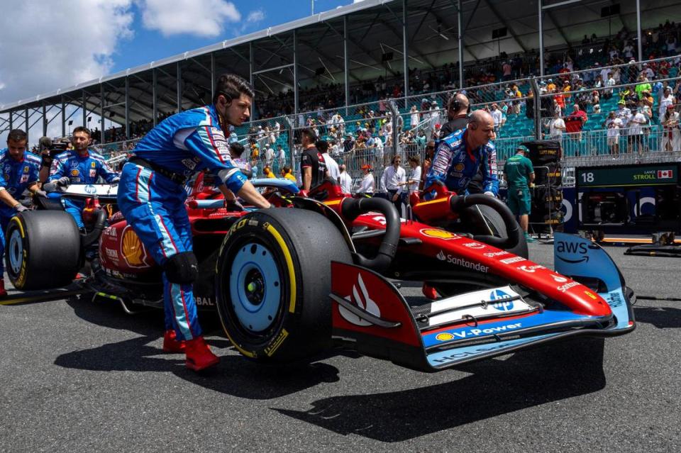 Members of the Ferrari racing team move Charles Leclerc’s car to the grid for the start of the Sprint race during day two of Formula One Miami Grand Prix.