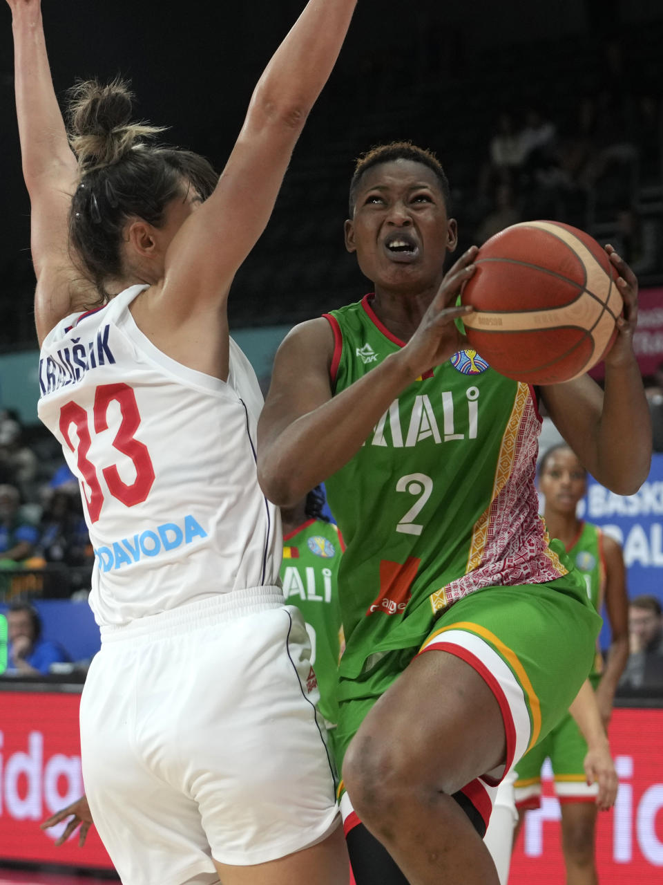 Mali's Salimatou Kourouma, right, is tries to lay up past Serbia's Tina Krajisnik during their game at the women's Basketball World Cup in Sydney, Australia, Monday, Sept. 26, 2022. (AP Photo/Rick Rycroft)