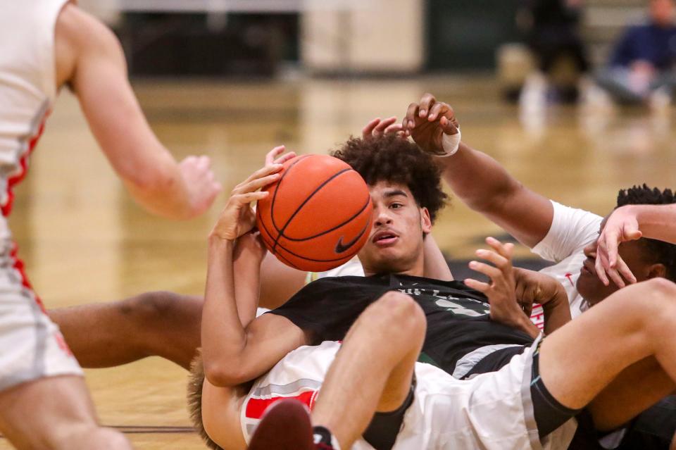 De La Salle's Javon Johnson (24) fights to keep a hold of the ball in a pile during the third period of their game at Xavier Prep High School, Thursday, Dec. 30, 2021, in Palm Desert, Calif.