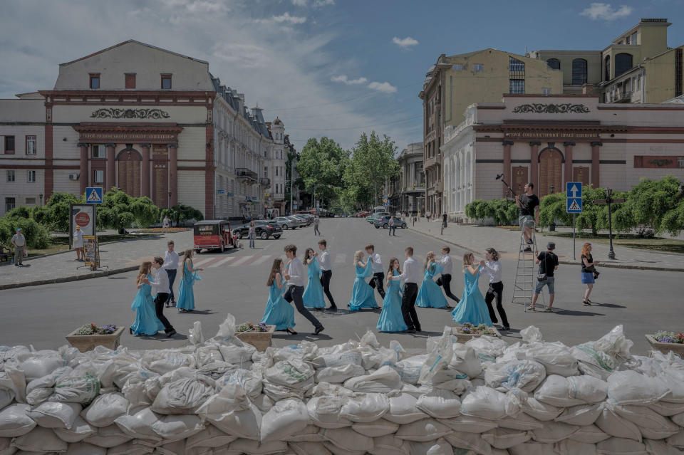 School graduates dance by sandbags protecting the front of the Opera Theater for a video to be posted online, in Odesa, Ukraine, on June 15.<span class="copyright">Laetitia Vancon—The New York Times/Redux</span>