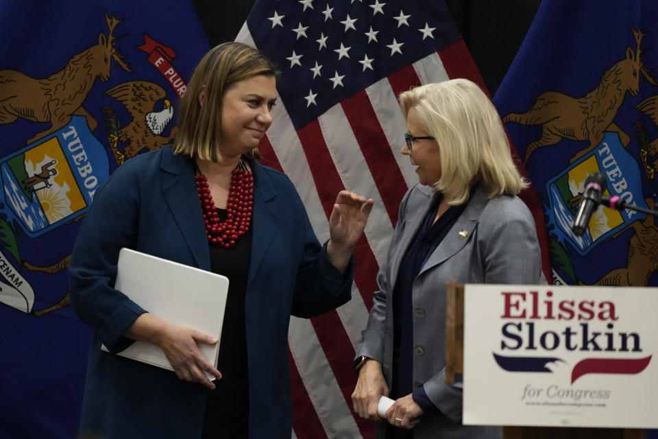 Reps. Elissa Slotkin, left, D-Mich., an Liz Cheney, R-Wyo., leave a campaign rally Tuesday, Nov. 1, 2022, in East Lansing, Mich., where Slotkin received the support of Cheney. Slotkin emphasized how a shared concern for a functioning democracy can unite Democrats and Republicans despite policy disagreements. (AP Photo/Carlos Osorio)