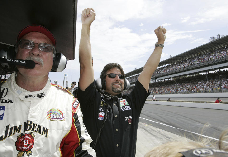 FILE - Car owner Michael Andretti celebrates in the pits as one of his drivers, Dan Wheldon, clinches victory in the 89th running of the Indianapolis 500 at Indianapolis Motor Speedway on Sunday, May 29, 2005, in Indianapolis. Person at left is not identified. American Michael Andretti cleared a major hurdle in his bid to launch a Formula One team as the FIA said Monday, Oct. 2, 2023, that he meets all required criteria to expand the world's top motorsports series to 11 teams.(AP Photo/Tom Strattman, File)