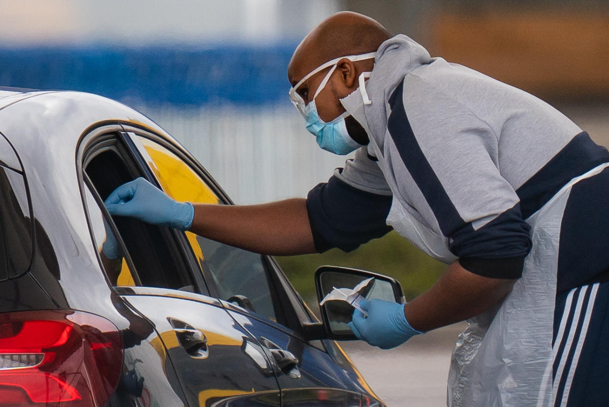 Medical staff at an NHS drive through coronavirus disease (COVID-19) testing facility in an IKEA car park, Wembley as the UK continues in lockdown to help curb the spread of the coronavirus.