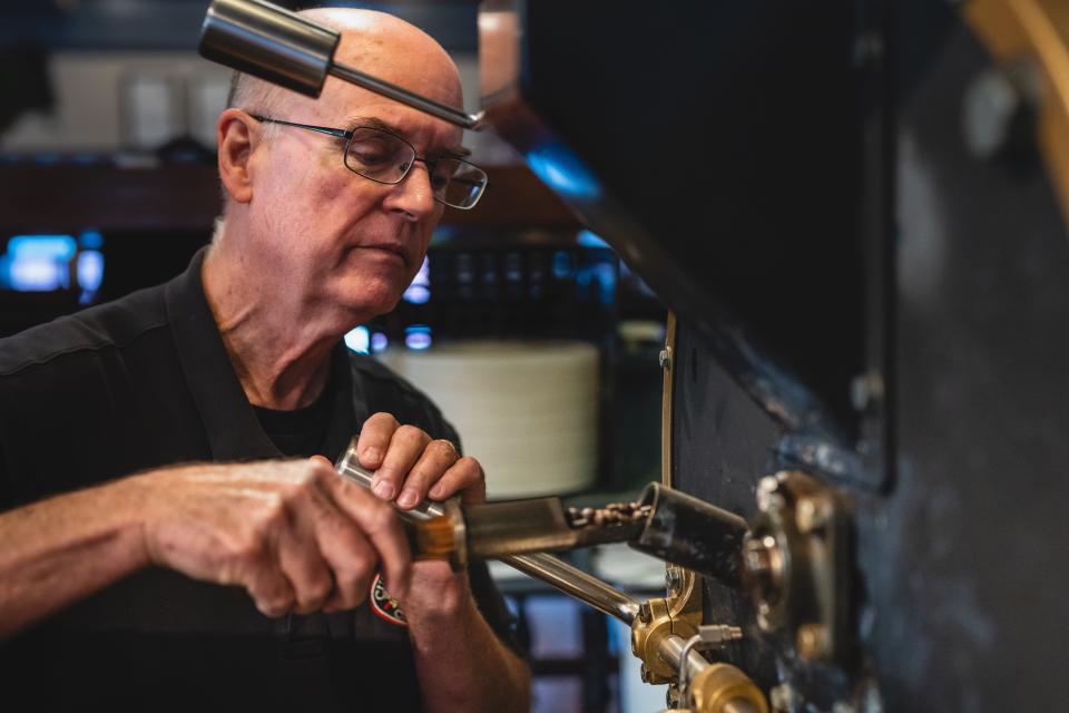 Bob Mastin checks the beans as they’re roasting. The beans are heated to around 420 degrees for a lighter roast and 460 degrees for a darker roast.