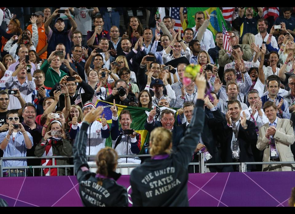 The United State's Misty May-Treanor, left, and Kerri Walsh Jennings acknowledge the crowd with their Gold Medals following a win over April Ross and Jennifer Kessy in the women's Gold Medal beach volleyball match between two United States teams at the 2012 Summer Olympics, Wednesday, Aug. 8, 2012, in London. 