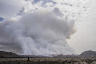 A cloud of smoke billows as a volcano erupts in Grindavik, Iceland, Wednesday, May 29, 2024. A volcano in southwestern Iceland is erupting, spewing red streams of lava in its latest display of nature's power. A series of earthquakes before the eruption Wednesday triggered the evacuation of the popular Blue Lagoon geothermal spa. The eruption began in the early afternoon north of Grindavik, a coastal town of 3,800 people that was also evacuated. (AP Photo/Marco di Marco)