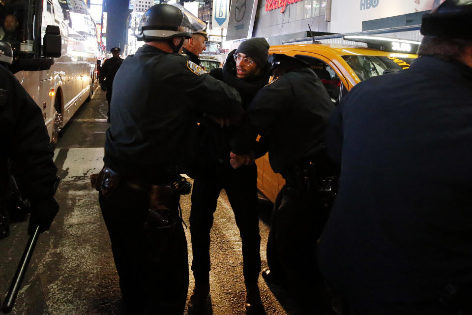 Police make arrests after protesters rallying against a grand jury's decision not to indict the police officer involved in the death of Eric Garner attempted to block traffic at the intersection of 42nd Street and Seventh Avenue near Times Square, Thursday, Dec. 4, 2014, in New York. (AP Photo/Jason DeCrow)