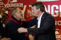 Republican gubernatorial candidate, Glen Youngkin, right, hugs Virginia Republican party chairman, Rich Anderson, as he arrives for an event in Richmond, Va., Tuesday, May 11, 2021. (AP Photo/Steve Helber)