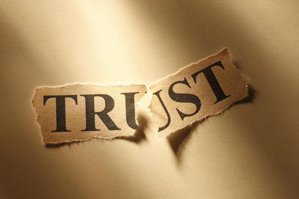 The word "Trust" torn in half