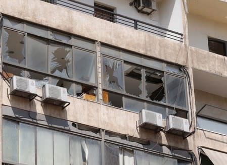 Broken windows are pictured after an Israeli drone fell in the Hezbollah-dominated southern suburbs and a second one exploded near the ground in Dahiyeh suburbs of Beirut