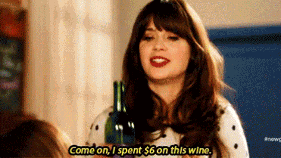 new girl gif of zooey deschanel, jessica day, holding a bottle of wine