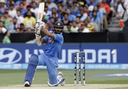 India's Shikhar Dhawan hits a boundary during the Cricket World Cup match against South Africa at the Melbourne Cricket Ground (MCG) February 22, 2015. REUTERS/Hamish Blair