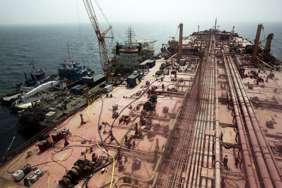 FILE - Technical vessels are seen by the decrepit 'Safer' tanker on Monday, June 12, 2023, off the coast of Yemen. A senior United Nations official says a salvage team is set to begin siphoning oil out of the decaying tanker moored off the coast of Yemen. (AP Photo/Osamah Abdulrahman, File)