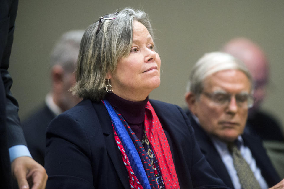 Dr. Eden Wells listens as Genesee District Judge William Crawford reads through a prepared statement during a hearing Friday, Dec. 7, 2018, at Genesee District Court in downtown Flint, Mich. Wells, Michigan's chief medical executive, will stand trial on involuntary manslaughter and other charges in a criminal investigation of the Flint water crisis, a judge ruled Friday. (Jake May/The Flint Journal via AP)