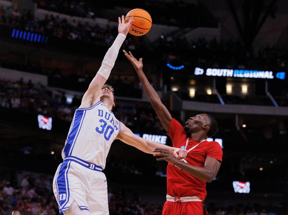 Duke’s Kyle Filipowski and N.C. State’s Mohamed Diarra battle for a rebound during the first half of the Wolfpack’s NCAA Tournament Elite Eight matchup on Sunday, March 31, 2024, at American Airlines Center in Dallas, Texas.