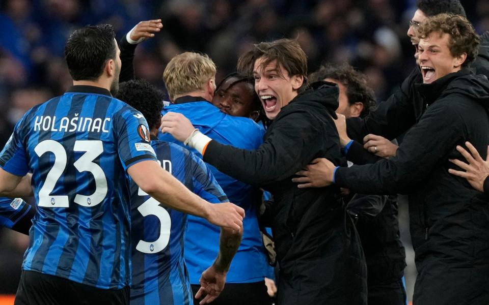 Atalanta's Ademola Lookman, center, celebrates with his teammates after scoring his side's opening goal