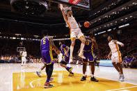 Tennessee forward Uros Plavsic (33) dunks the ball over LSU forward Tari Eason (13) during the first half of an NCAA college basketball game Saturday, Jan. 22, 2022, in Knoxville, Tenn. (AP Photo/Wade Payne)