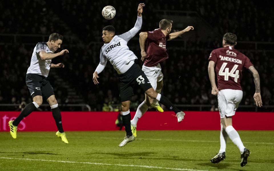 Curtis Davies (centre left) challenges for the ball with Northampton Town's Andy Williams during Friday's stalemate - CameraSport