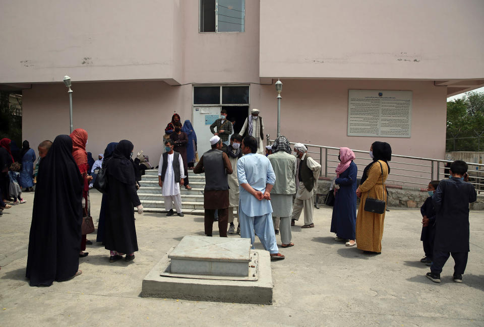 Families of newborns wait outside the Ataturk hospital to see their children in Kabul on May 13, a day after they were rescued following a deadly attack on another maternity hospital. | Rahmat Gul—AP