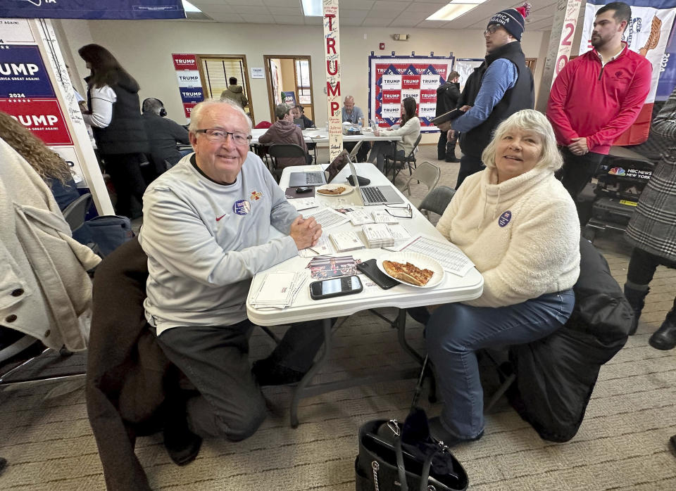 Volunteers Mike Schultz, left, and Miriam Schultz work at former president Donald Trump's campaign headquarters in the closing days ahead of the GOP Iowa caucus on Saturday, Jan. 13, 2024, in Urbandale, Iowa. (AP Photo/Jill Colvin)