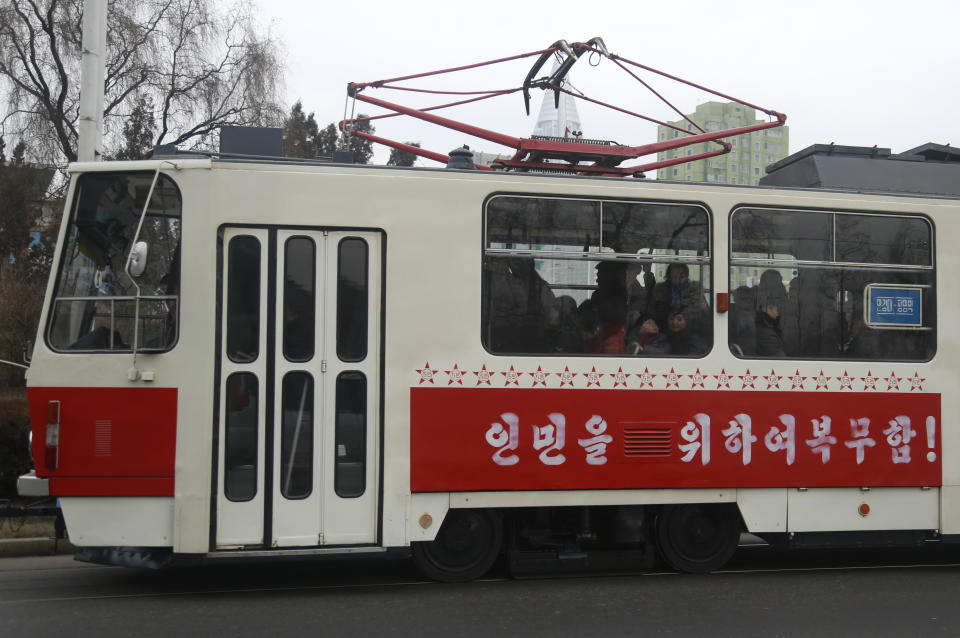 In this Saturday, Feb. 2, 2019 photo, people ride on a tram with red stars stenciled across its side in Pyongyang, North Korea. Pyongyang is upgrading its overcrowded mass transit system with brand new subway cars, trams and buses in a campaign meant to show leader Kim Jong Un is raising the country's standard of living. The red stars are awarded for every 50,000 kilometers (31,000 miles) driven without an accident. (AP Photo/Dita Alangkara)