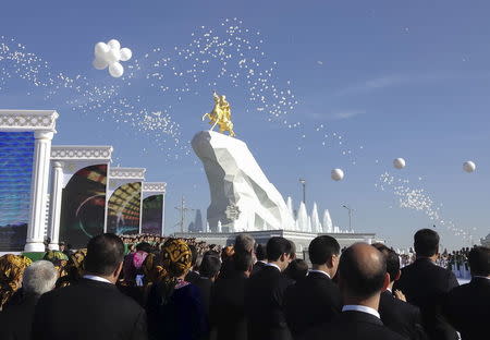 People gather in front of a monument to Turkmenistan's President Kurbanguly Berdymukhamedov during its inauguration ceremony in Ashgabat, Turkmenistan, May 25, 2015. REUTERS/Marat Gurt