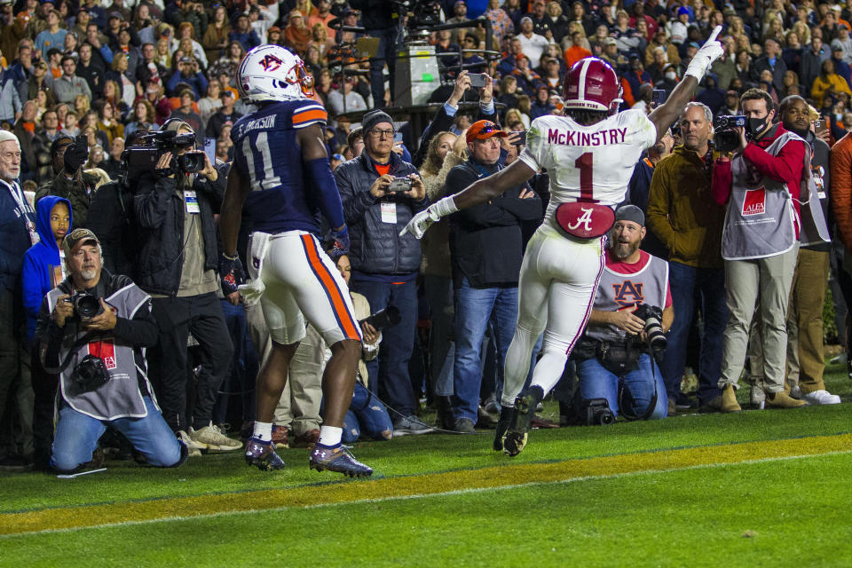Alabama defensive back Kool-Aid McKinstry (1) celebrates after deflecting the ball from Auburn wide receiver Shedrick Jackson (11) during the fourth and final overtime of an NCAA college football game, Saturday, Nov. 27, 2021, in Auburn, Ala. The deflection helped Alabama win on their following possession. (AP Photo/Vasha Hunt)