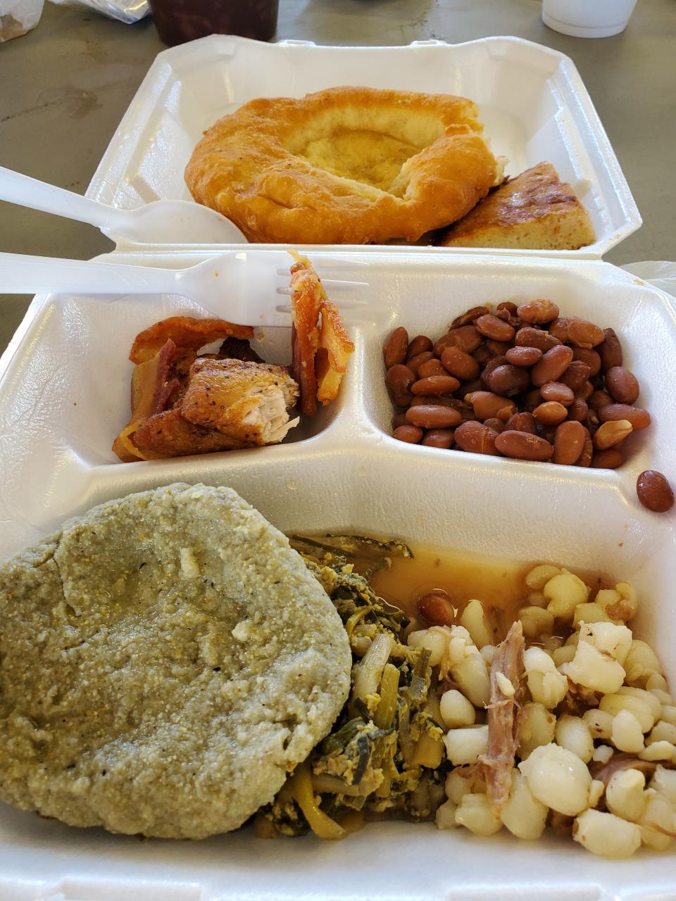 A traditional Muscogee (Creek) wild onion dinner is pictured, featuring blue corn bread, hominy, pork, beans, fry bread and skillet bread.