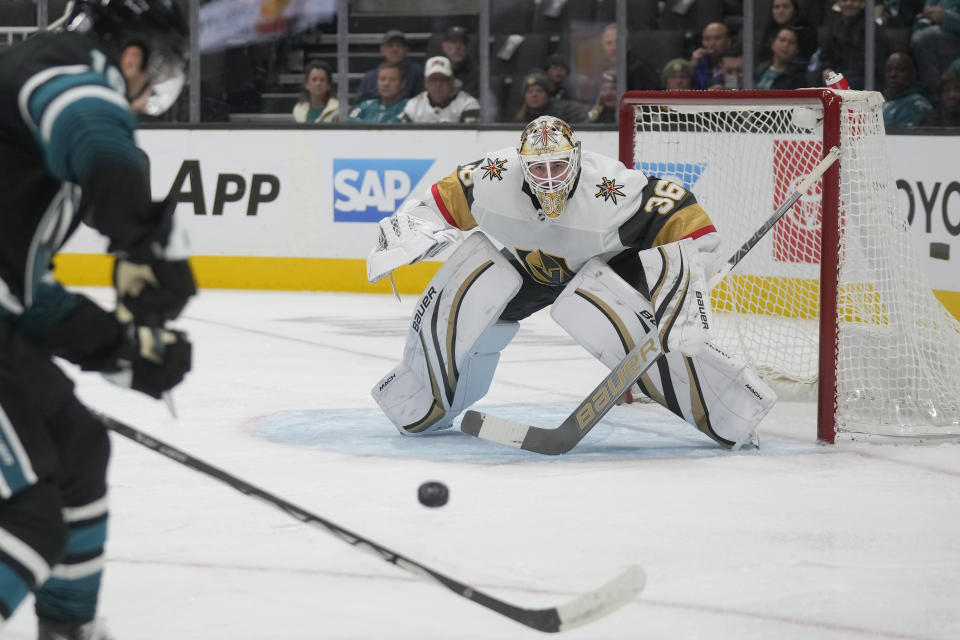 Vegas Golden Knights goaltender Logan Thompson (36) watches the puck as San Jose Sharks right wing Filip Zadina, left, skates forward during the first period of an NHL hockey game in San Jose, Calif., Monday, Feb. 19, 2024. (AP Photo/Jeff Chiu)