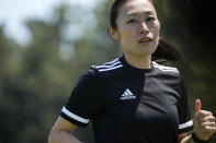 Japanese referee Yoshimi Yamashita warms up during a training session Monday, June 27, 2022, at JFA YUME Field in Chiba, near Tokyo. Yamashita is one three three women picked in a pool of 36 head referees for the men's World Cup in Qatar, which opens in just under five months on Nov. 21. It's the first time a female will be in charge on soccer largest stage. (AP Photo/Eugene Hoshiko)