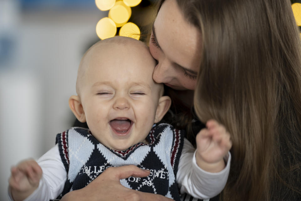 Vlada Yushchenko, a 19-year-old Ukrainian refugee, holds her son Daniel, during an interview with The Associated Press in Brasov, Romania, Thursday, Feb. 2, 2023. Yushchenko was still in her teens and nearly three months pregnant when she hugged her husband at the border, turned away and walked into Moldova. Now she’s in Romania, one of the millions of Ukrainians forced to flee Russia’s invasion of their country. Her baby, Daniel, was born there eight months ago and still hasn’t met his father Yaroslav, who is 21 and, like most men of fighting age, prohibited from leaving Ukraine. (AP Photo/Vadim Ghirda)