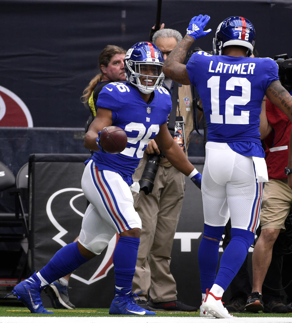 New York Giants running back Saquon Barkley (26) celebrates with Cody Latimer (12) after rushing for a touchdown against the Houston Texans during the first half of an NFL football game Sunday, Sept. 23, 2018, in Houston. (AP Photo/Eric Christian Smith)