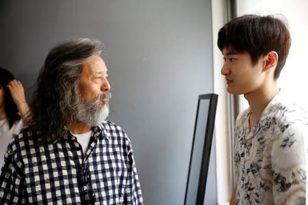 South Korean senior model Kim Chil-doo, 65-years-old, talks with a model during a practice session in Seoul