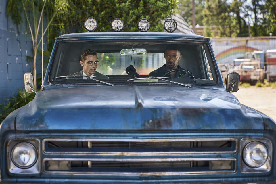 This image released by Netflix shows Dave Franco, left, and Jamie Foxx in a scene from "Day Shift." (Parrish Lewis/Netflix via AP)