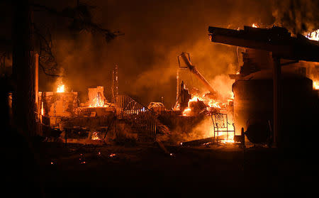 Flames consume a garage as the Ponderosa Fire burns east of Oroville, California, U.S. August 29, 2017. REUTERS/Noah Berger