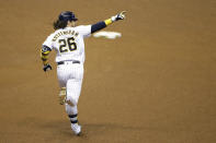 Milwaukee Brewers' Jacob Nottingham gestures after hitting a grand slam during the fourth inning of a baseball game against the Kansas City Royals, Friday, Sept. 18, 2020, in Milwaukee. (AP Photo/Aaron Gash)