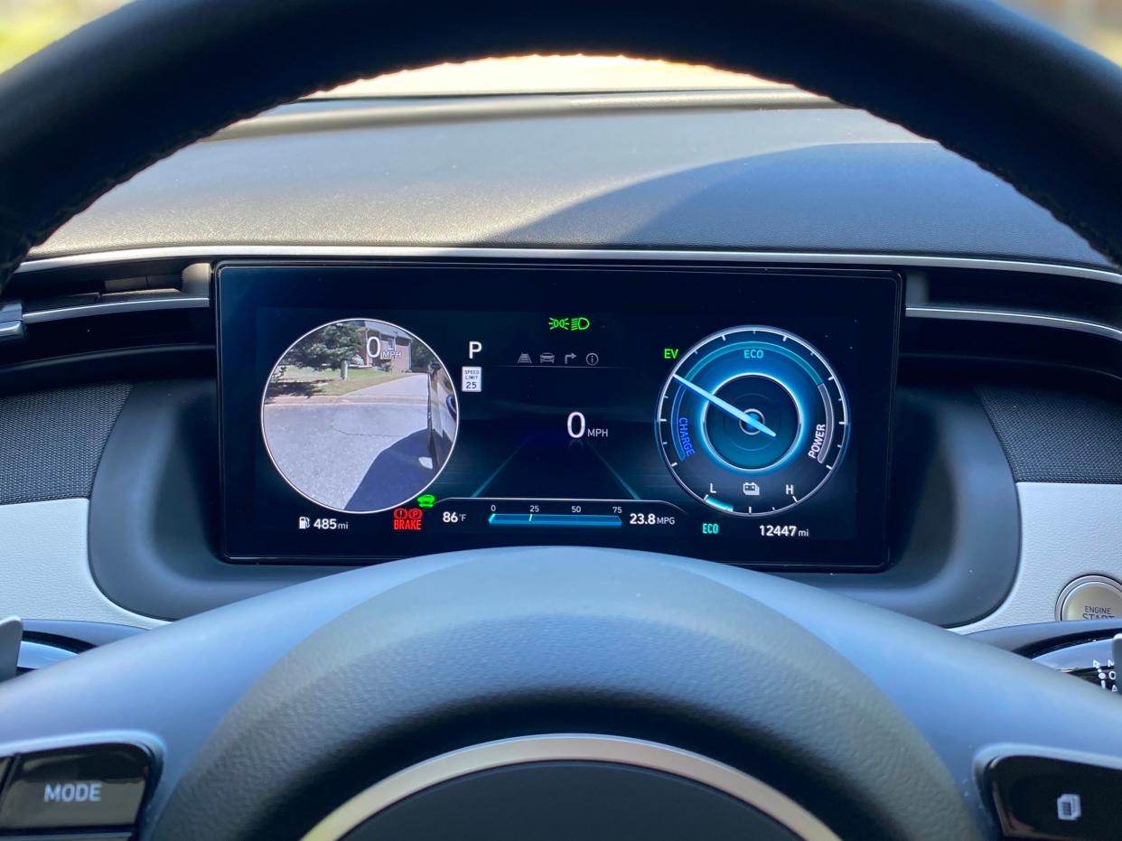 The Hyundai Tucson Hybrid's instrument cluster with its driver's side blind spot monitor camera activated.