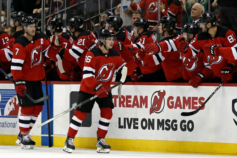 New Jersey Devils center Jack Hughes (86) celebrates with teammates after scoring a goal against the Chicago Blackhawks during the second period of an NHL hockey game Friday, Oct. 15, 2021, in Newark, N.J. (AP Photo/Adam Hunger)